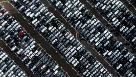  cars parked in parking spots in a giant parking lot